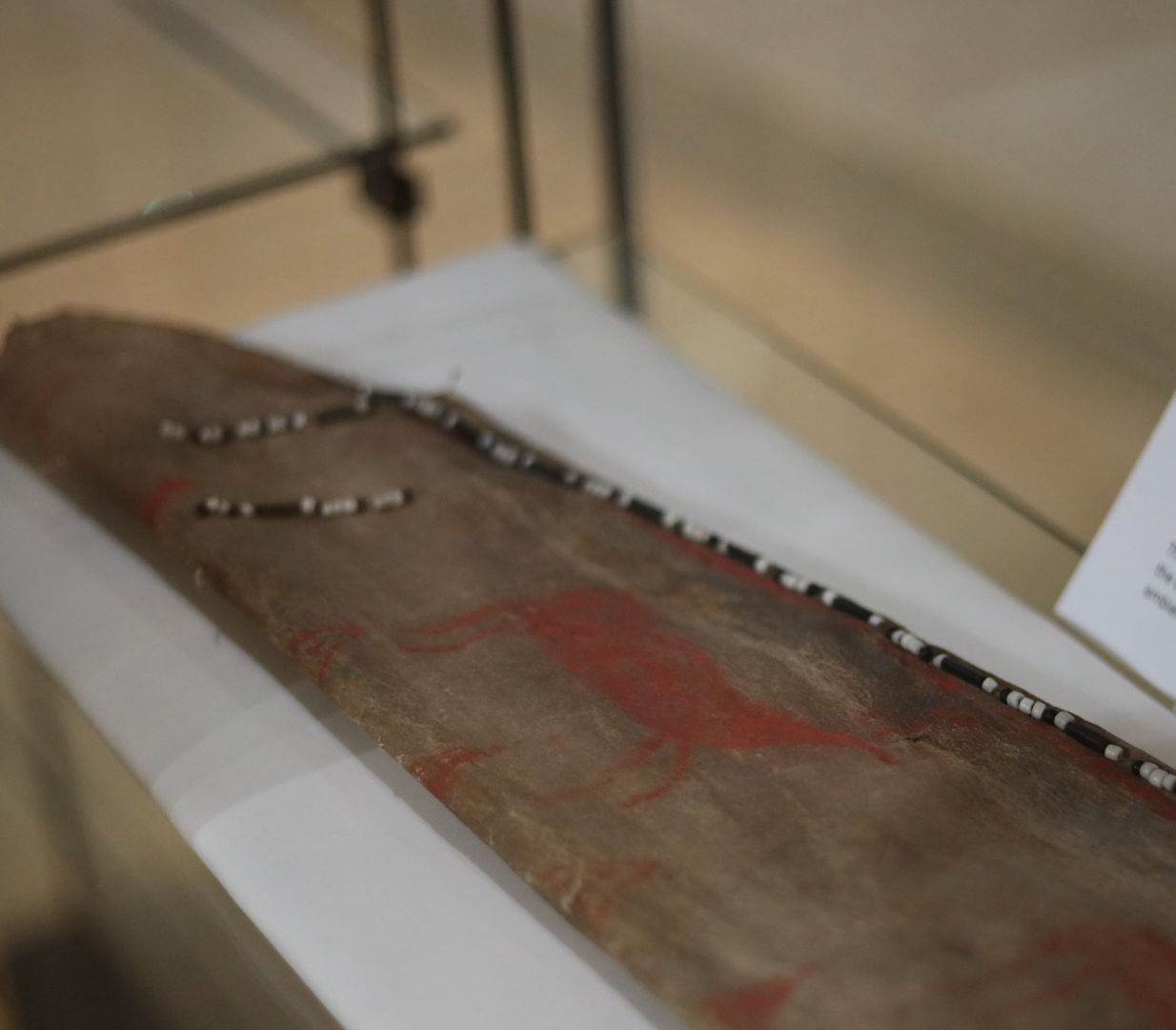 This Dena’ina arrow quiver, on display at the Alaska Native Heritage Center, includes ochre painting of caribou hunting and the three volcanoes surrounding the Kenai Peninsula. (Nathaniel Herz/Anchorage Press)
