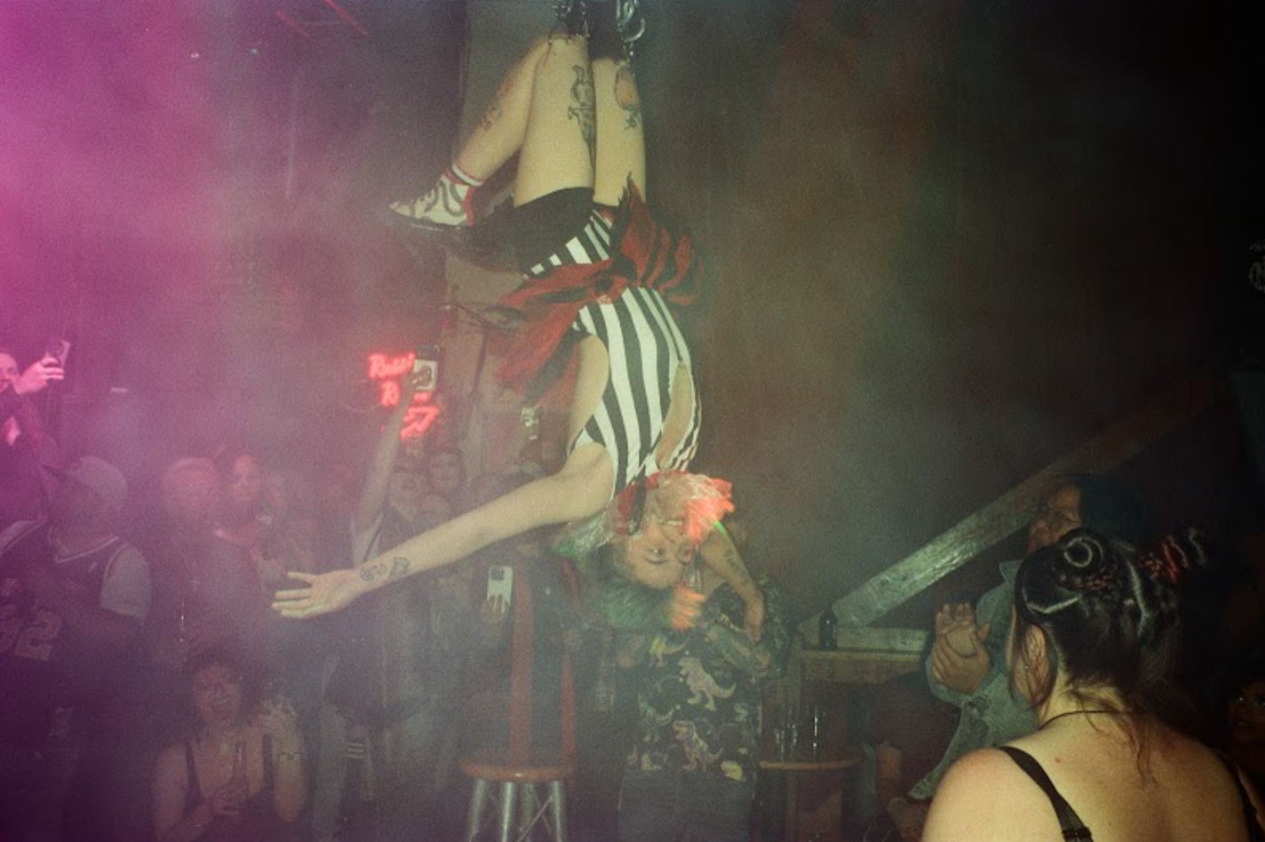 Alex Edwards hangs from the ceiling at Terrorwave. (Stephanie Sterling for the Anchorage Press)
