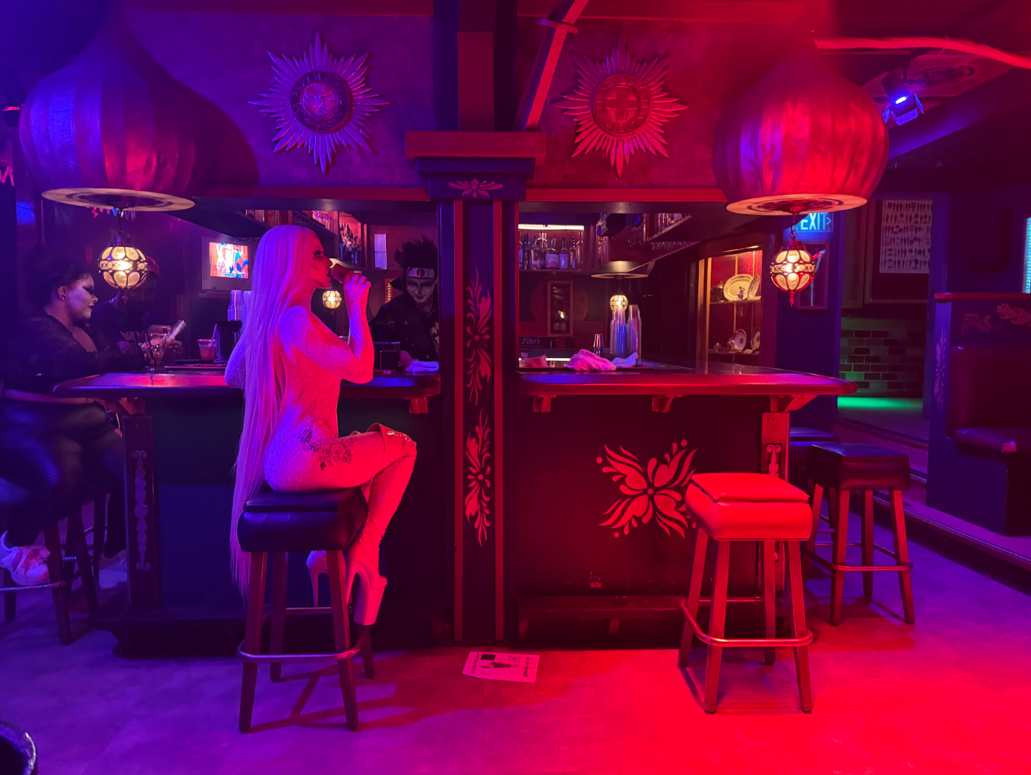 Upstairs in the Russian Room at Koot's, Scarlet Red enjoys a drink prepared by Jacob Bretey. (Stephanie Sterling for the Anchorage Press)