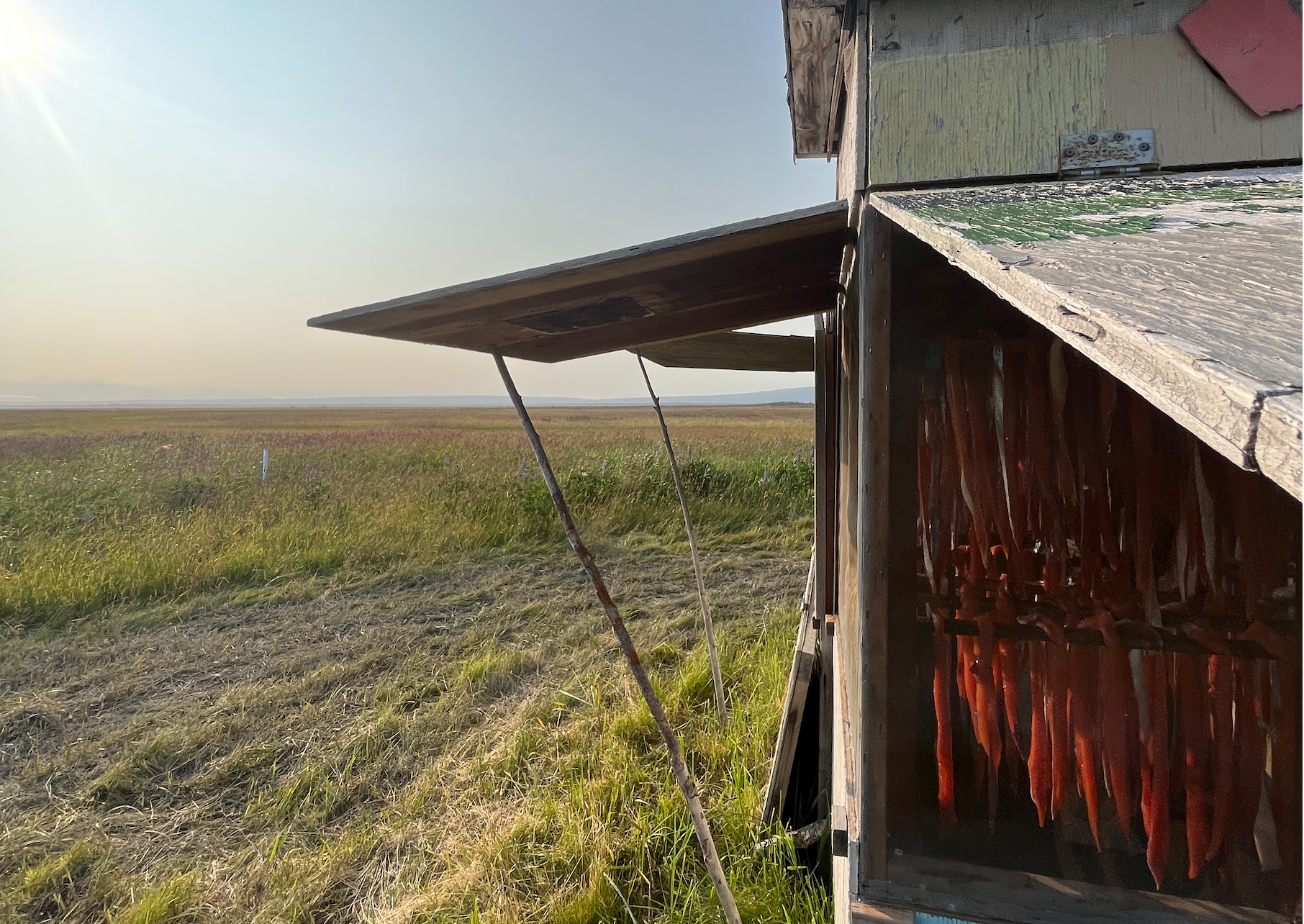 Salmon strips hang in a smokehouse. (Nathaniel Herz/Anchorage Press)