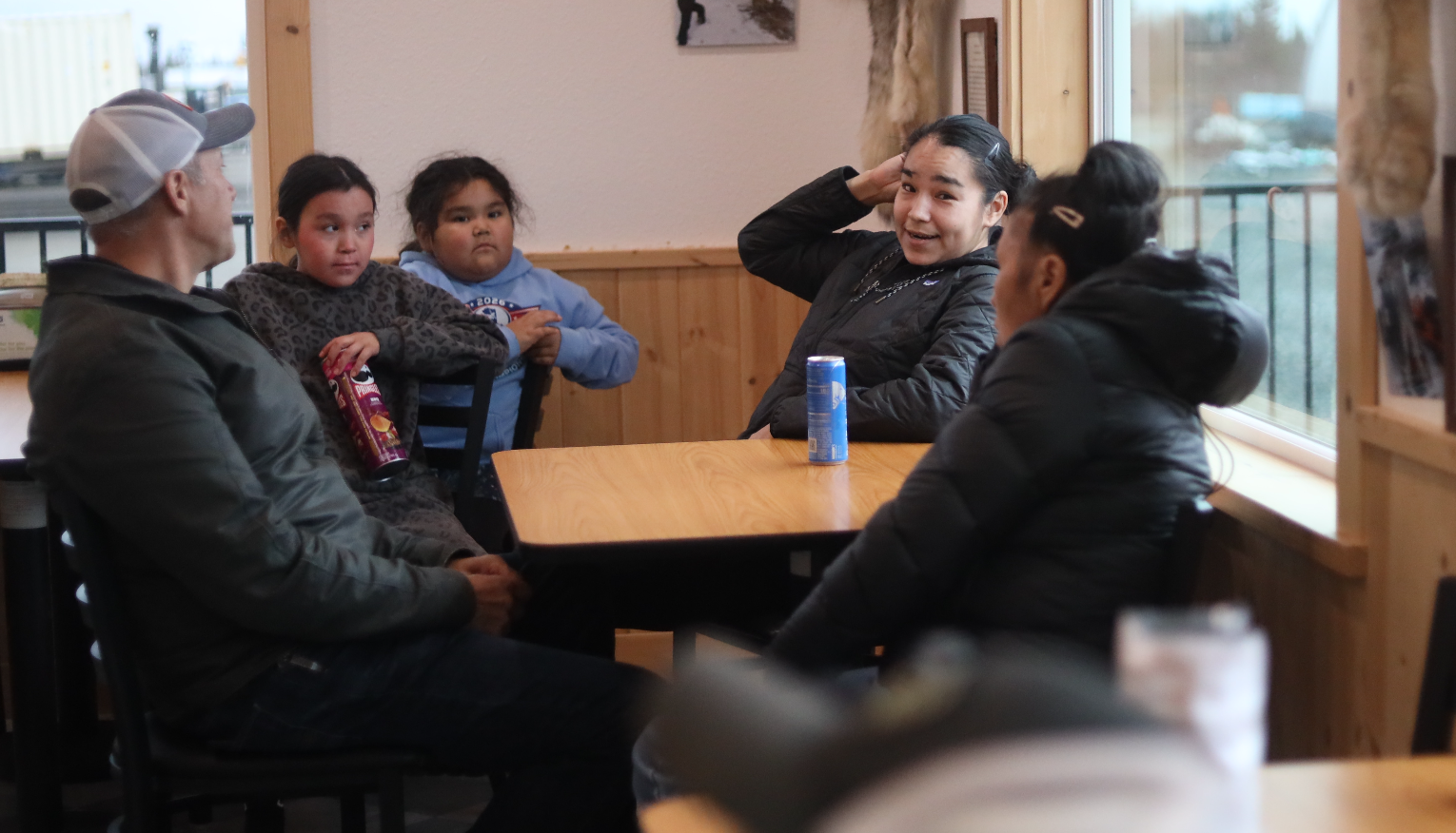 Jessie Wilson, center, chats with Bill Hill in Iliamna. (Nathaniel Herz/Anchorage Press)