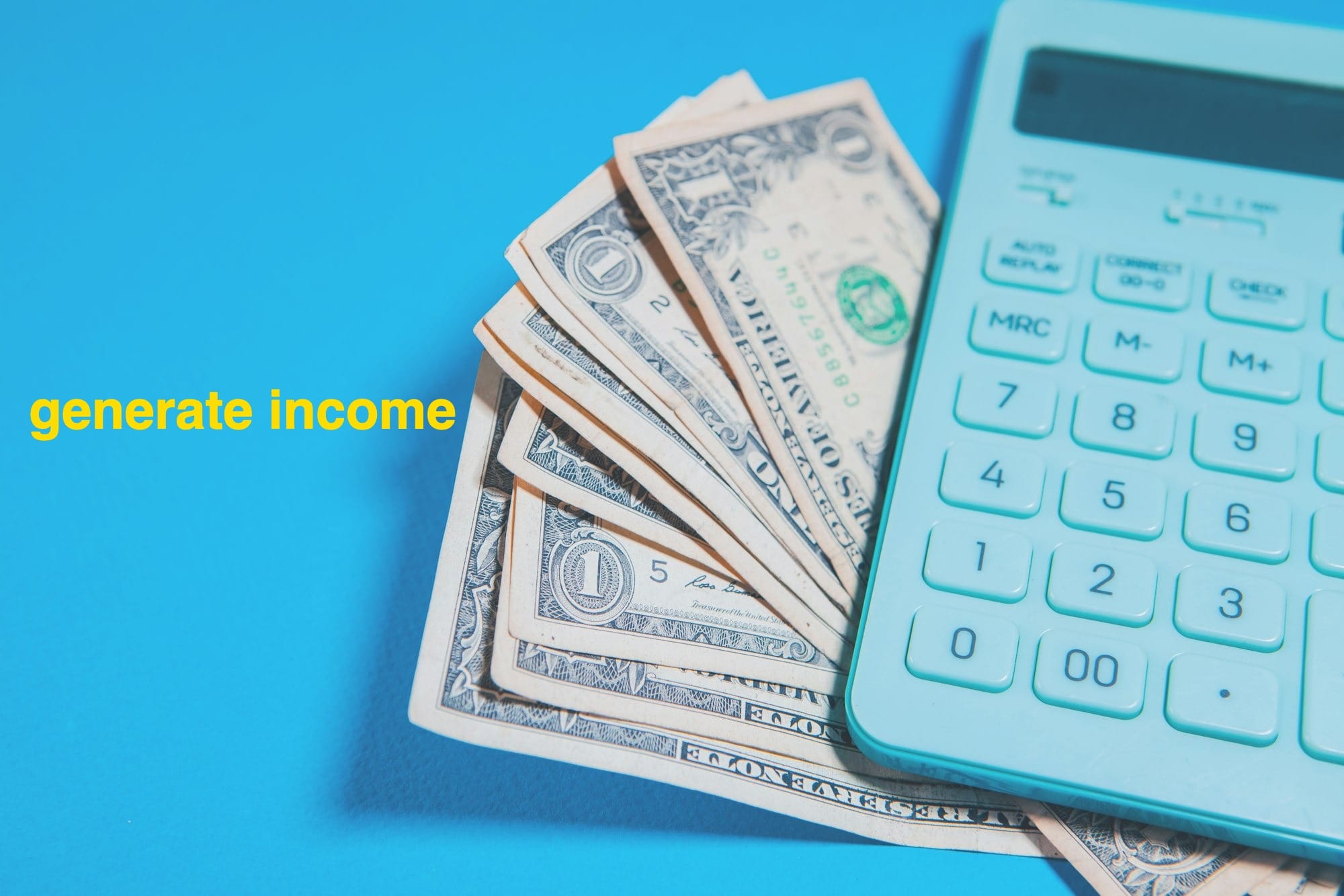 Us dollar bills and a calculator on blue background