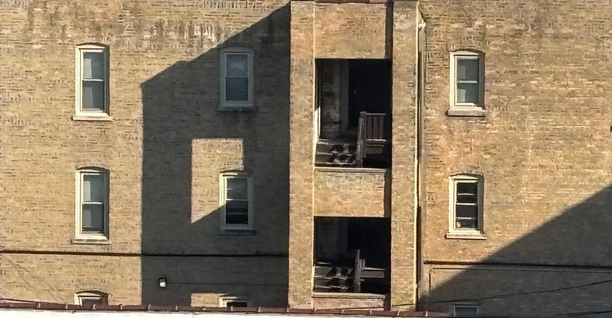 Close of up apartment building with shadows forming patterns.