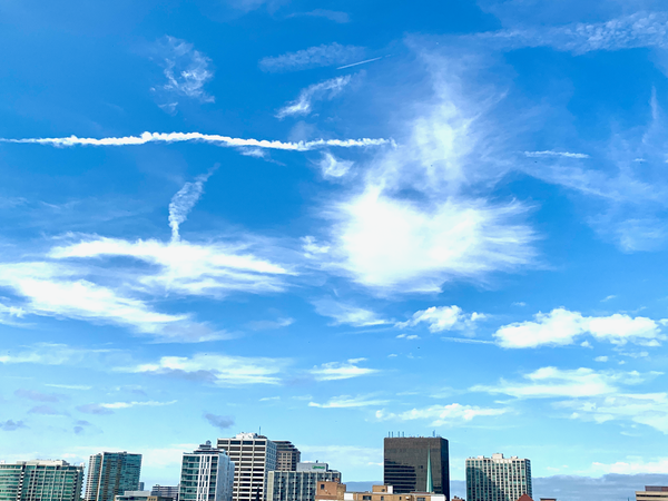 Blue sky and clouds above the downtEvanston skyline