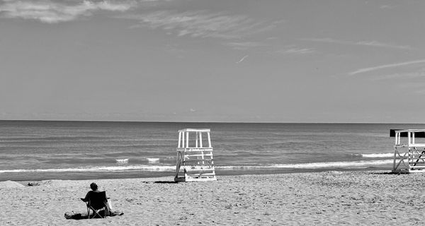 Evanston Dempster beach with lone person sitting in beach chair.