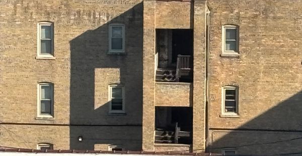 Close of up apartment building with shadows forming patterns.