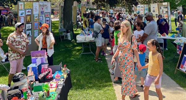Youth art show at an Evanston park, with people talking and looking at displays.