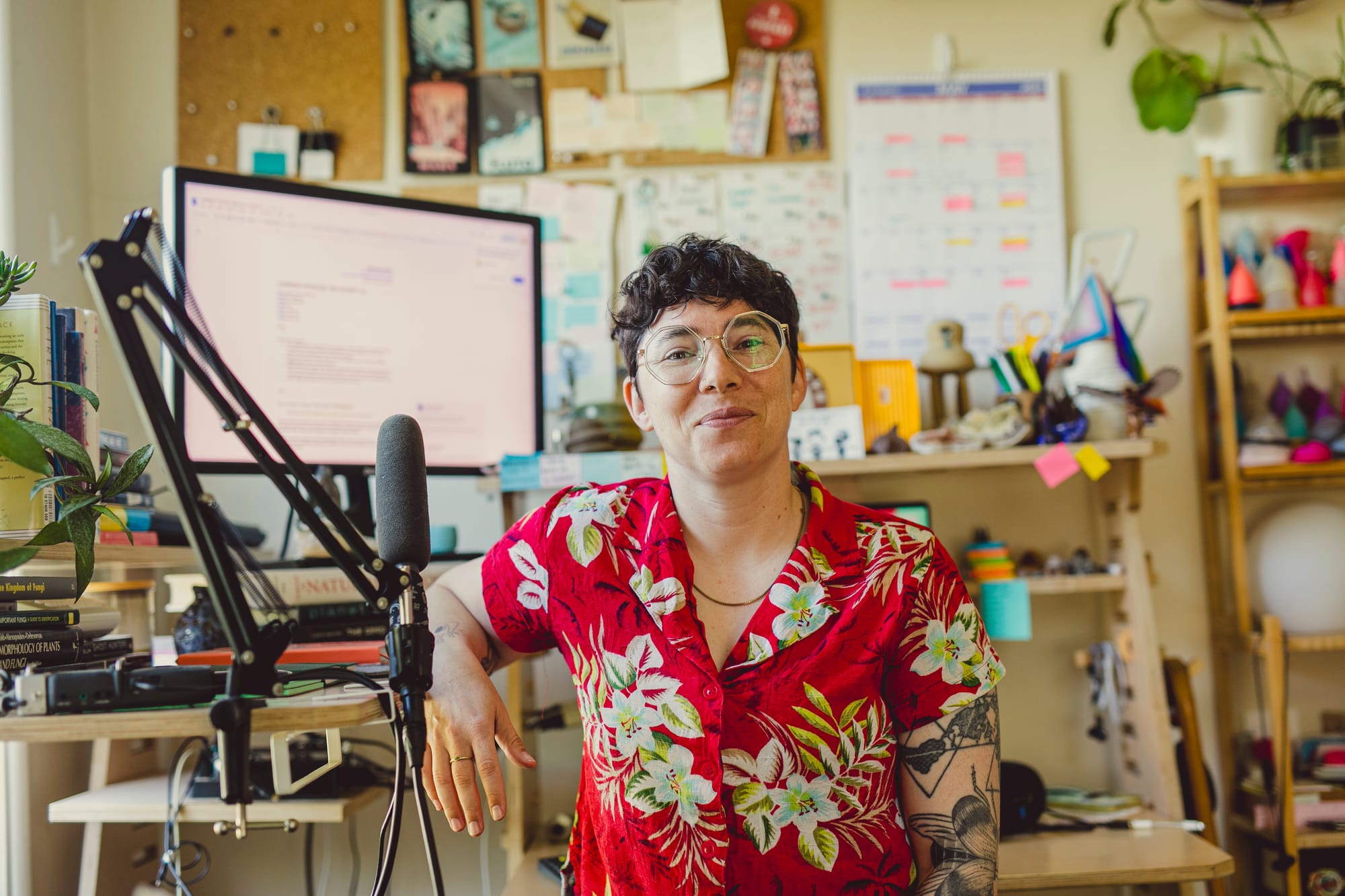 A photo of the journalist Rose Eveleth, wearing a red floral shirt and octagonal glasses