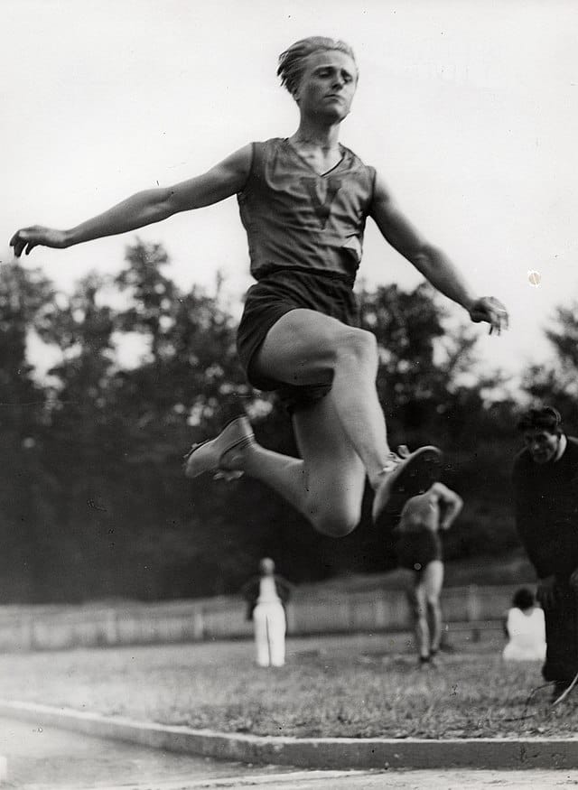 The Czech athlete Zdeněk Koubek leaping, potentially in the triple jump