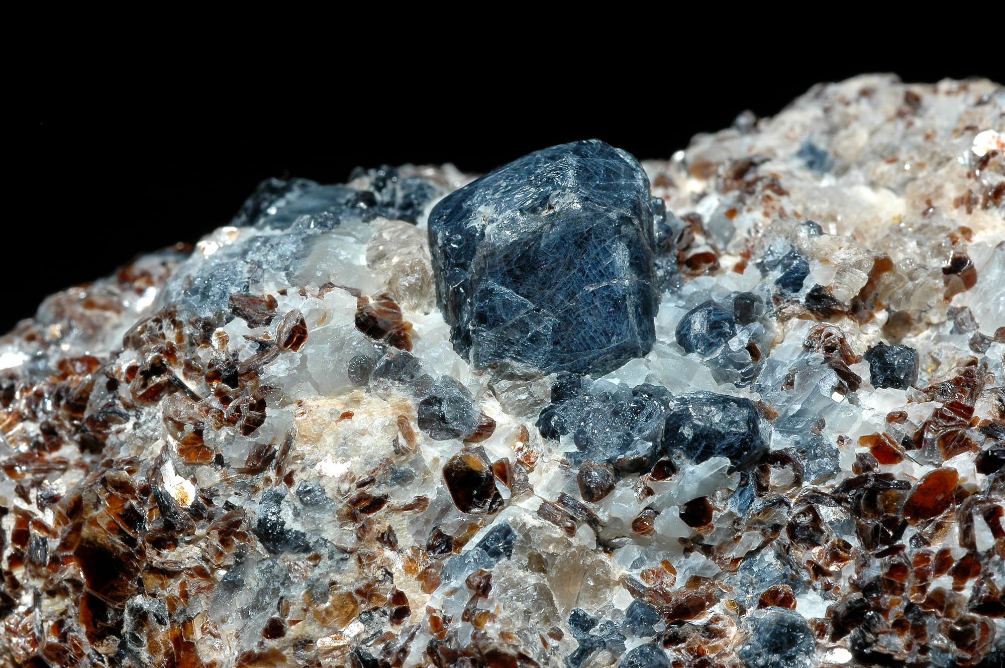 Sapphirine, a blue mineral surrounded by white and red minerals