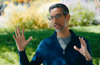 Image of the Alphabet Inc. CEO Sundar Pichai talking with his hands in the air, talking about the Q.1 earnings and AI related topics.