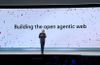 Microsoft CEO Satya Nadella onstage at Build 2025, standing in front of a large screen that reads “Building the open agentic web."