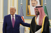 Donald Trump and Crown Prince Mohammed bin Salman smile and gesture during a meeting at the Royal Palace in Riyadh, Saudi Arabia, on May 13, 2025.