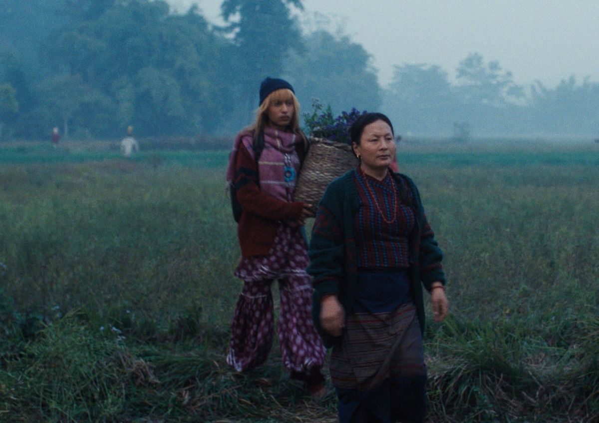 Puspa Thing Lama as Pirati walks through a misty field in Abinash Bikram Shah's Elephants in the Fog