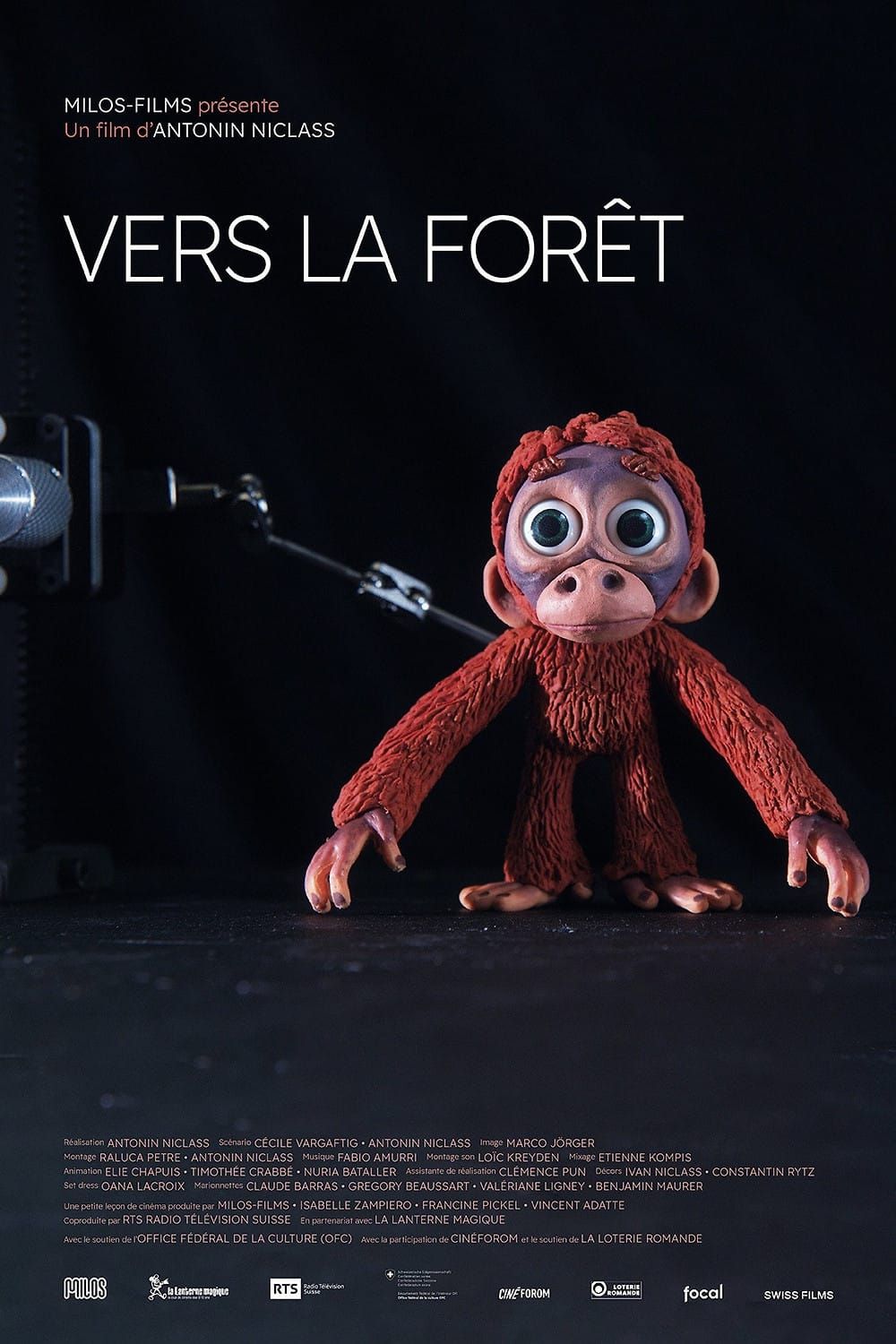 A small red clay monkey beside a stop-motion camera rig on the poster for Antonin Niclass's short Into the Forest