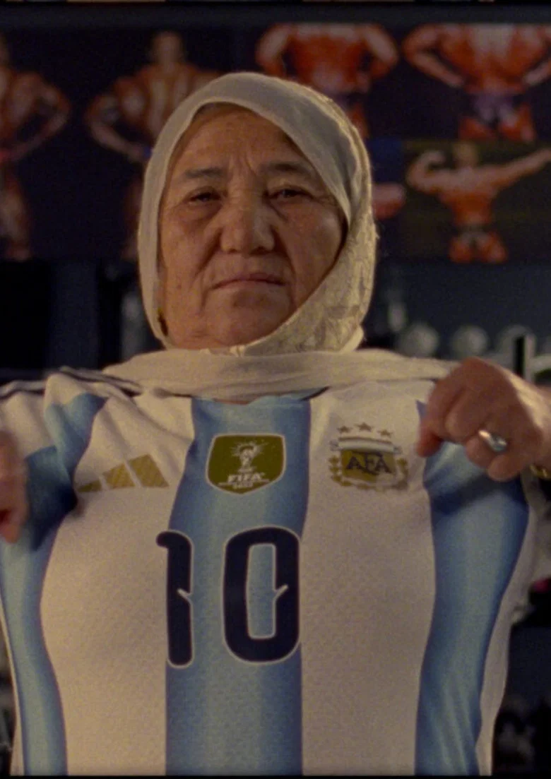 A woman holds up an Argentina number 10 shirt in Shahrbanoo Sadat's short Super Afghan Gym