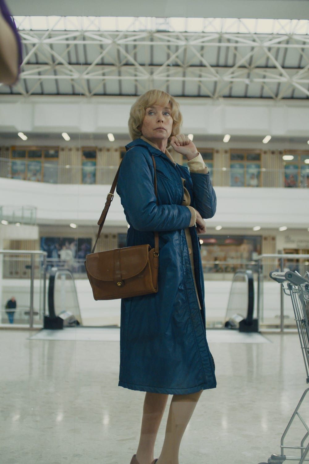 Julianne Nicholson as Dawn standing in an empty shopping centre in Camille Summers-Valli's short Untitled Woman
