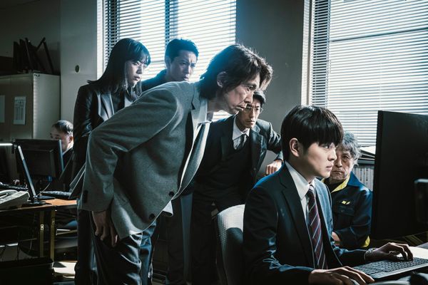 Detectives gather around a computer in a scene from Nameless (2026)