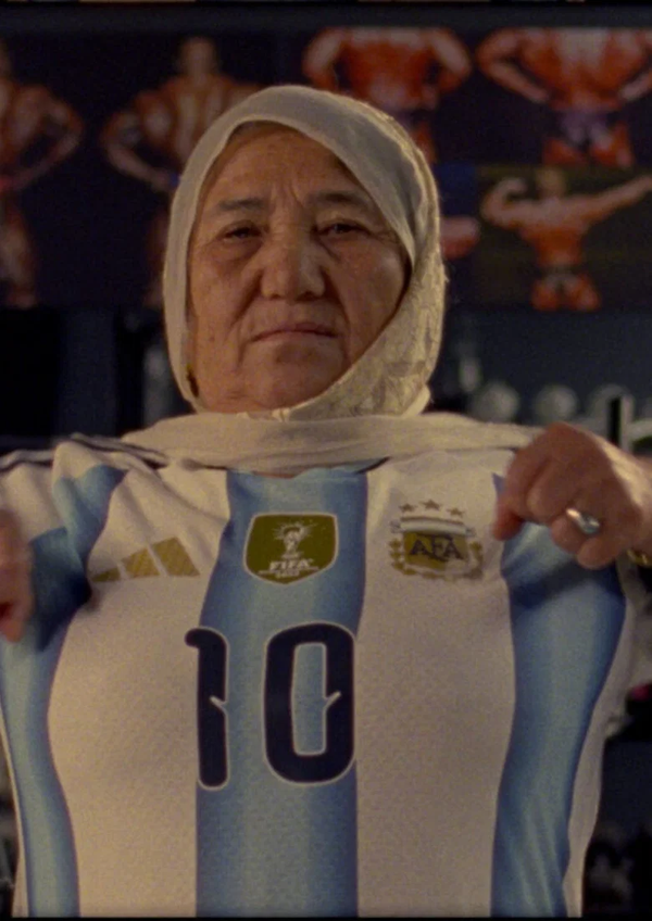A woman holds up an Argentina number 10 shirt in Shahrbanoo Sadat's short Super Afghan Gym