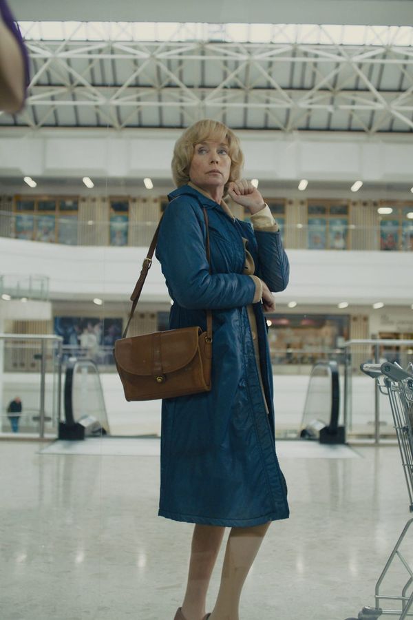 Julianne Nicholson as Dawn standing in an empty shopping centre in Camille Summers-Valli's short Untitled Woman