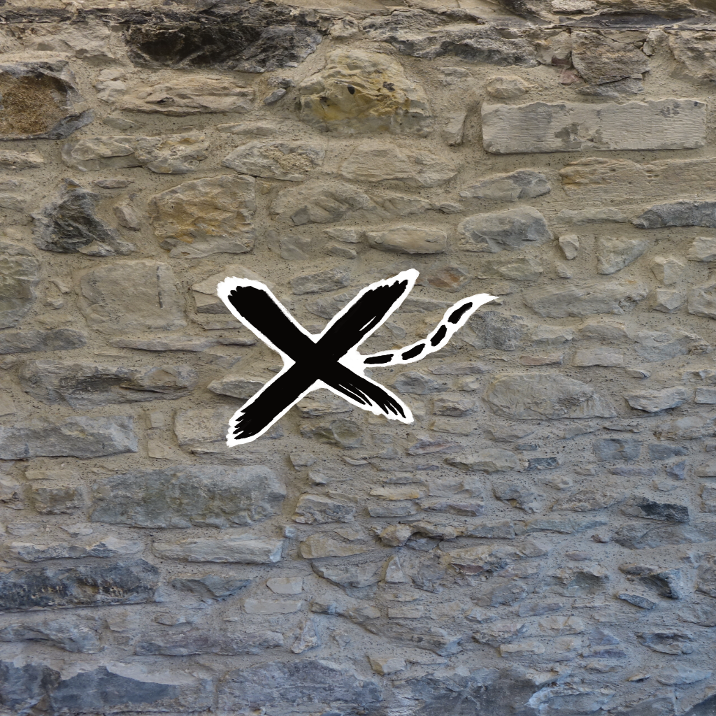 Random rubble sandstone wall in Pleasance Edinburgh superimposed with handwritten styled X 