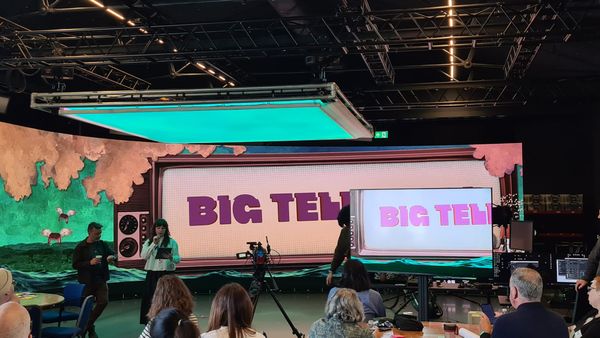Start of big telly jam showing eponymous image of jam and with presenters standing in front and audience looking on