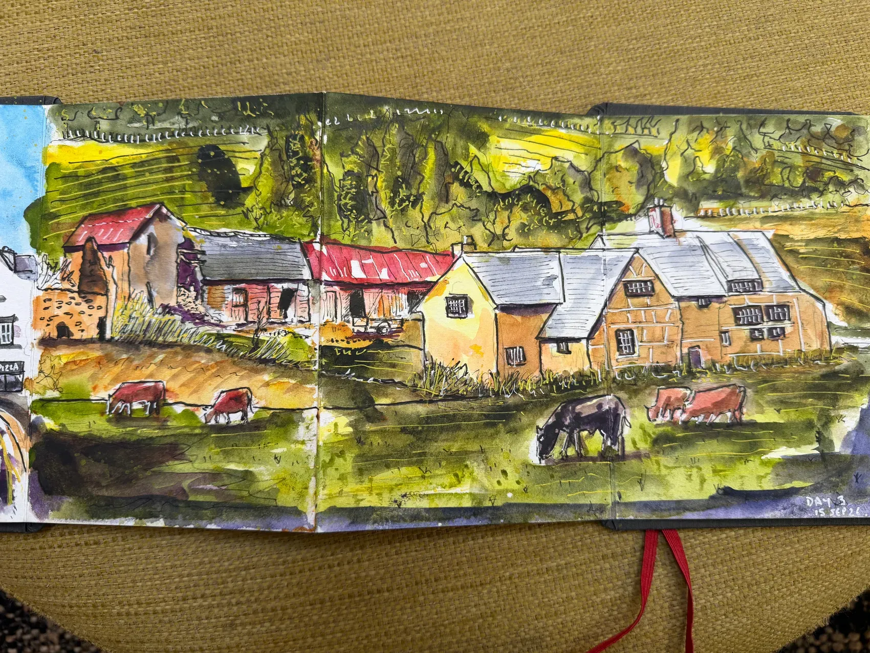 Farmhouse and fields, painted across the concertina sketchbook.