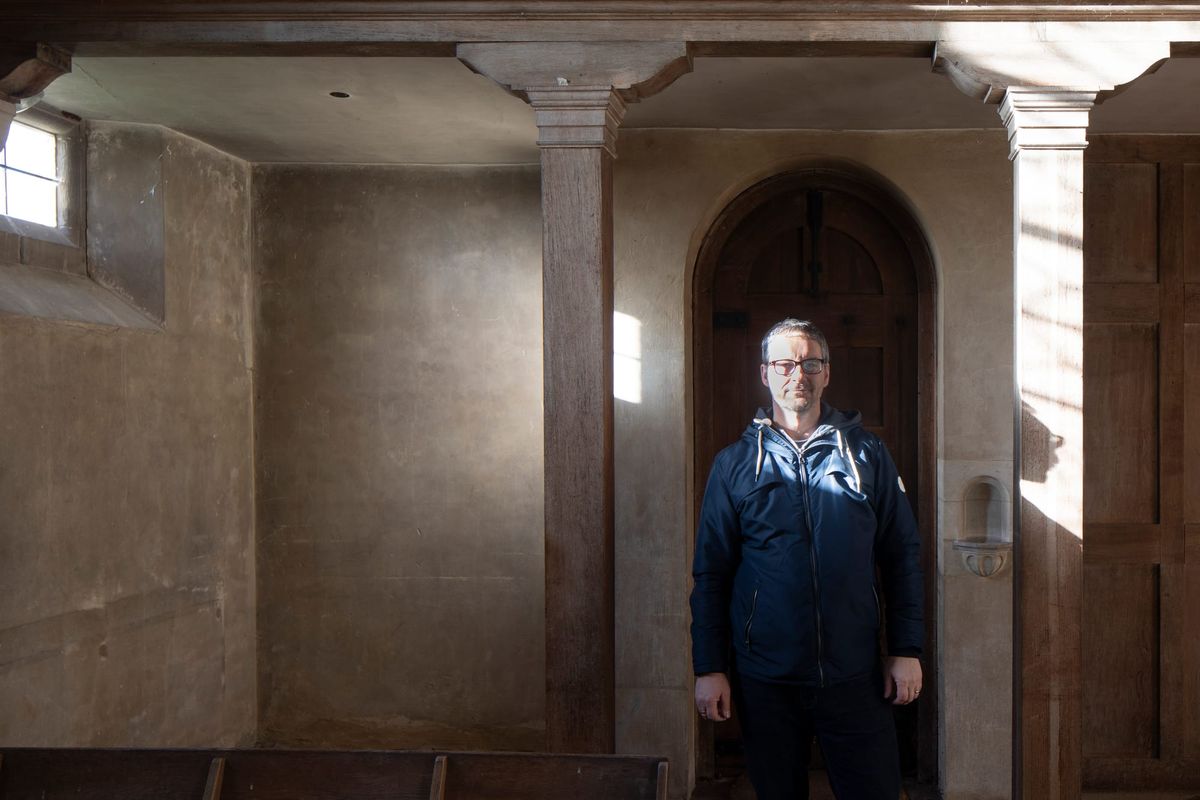 Andy Marshall standing within the quiet geometry of a historic interior