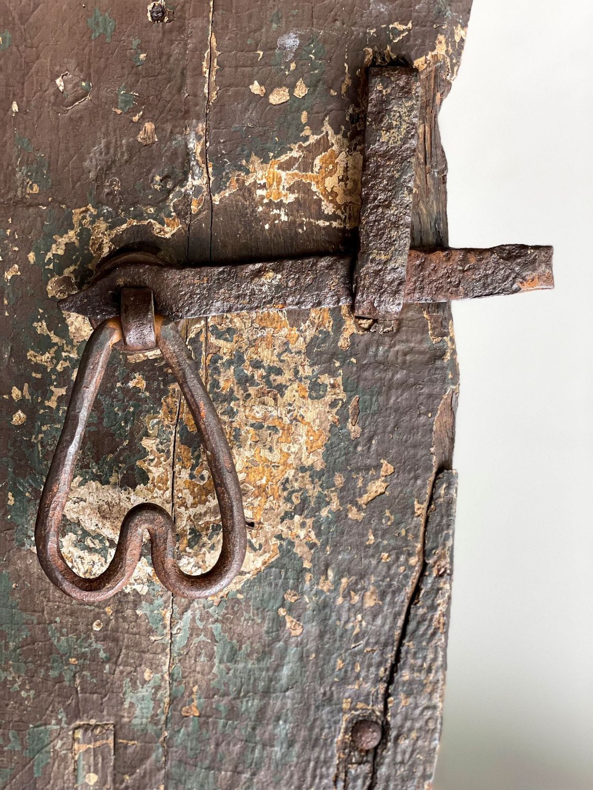 A handmade iron latch on the time-worn door at Tuxlith Chapel