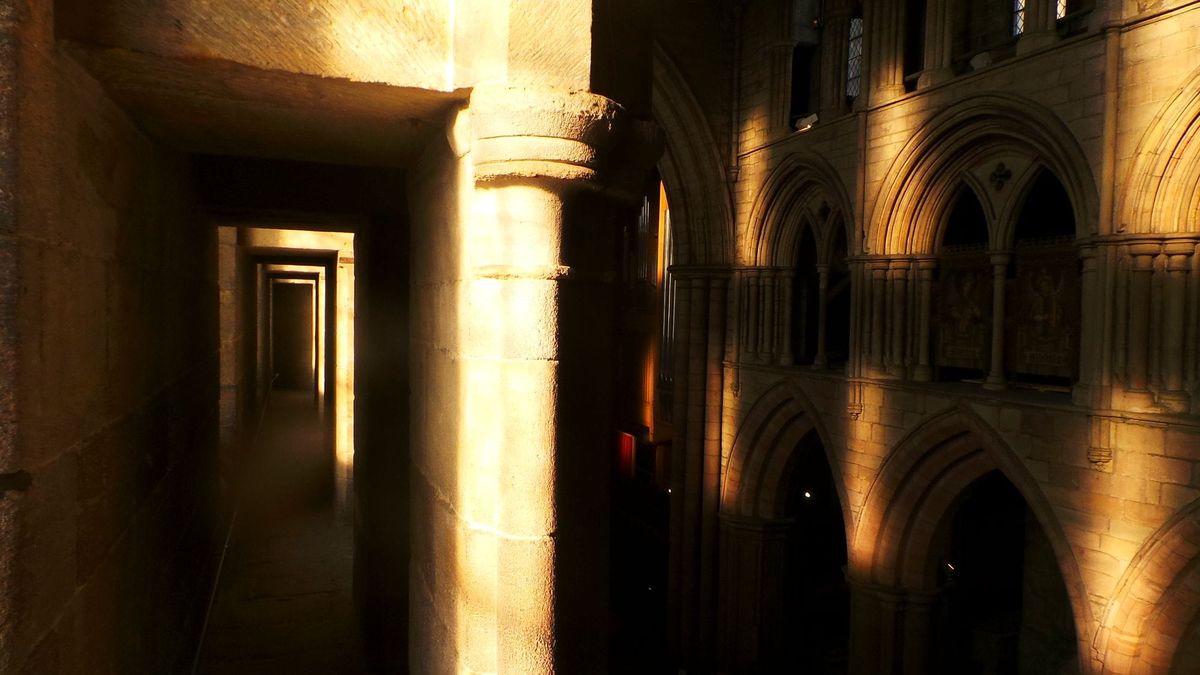 Golden light passing through the stone arcades at Hexham Abbey