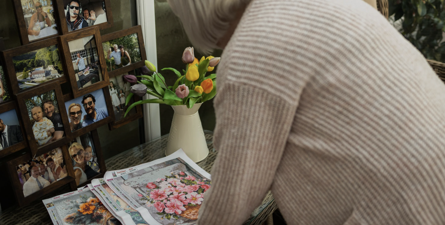 Lynne looks over her bead art, a creative outlet that offers her a rare moment of calm but meaningful escape from the demands of caring