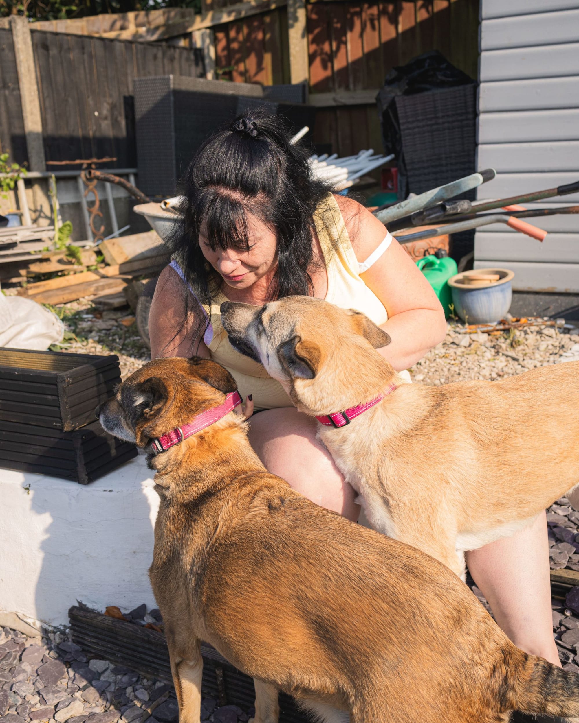 Colette shares a quiet moment with her two dogs, Queenie and Misty