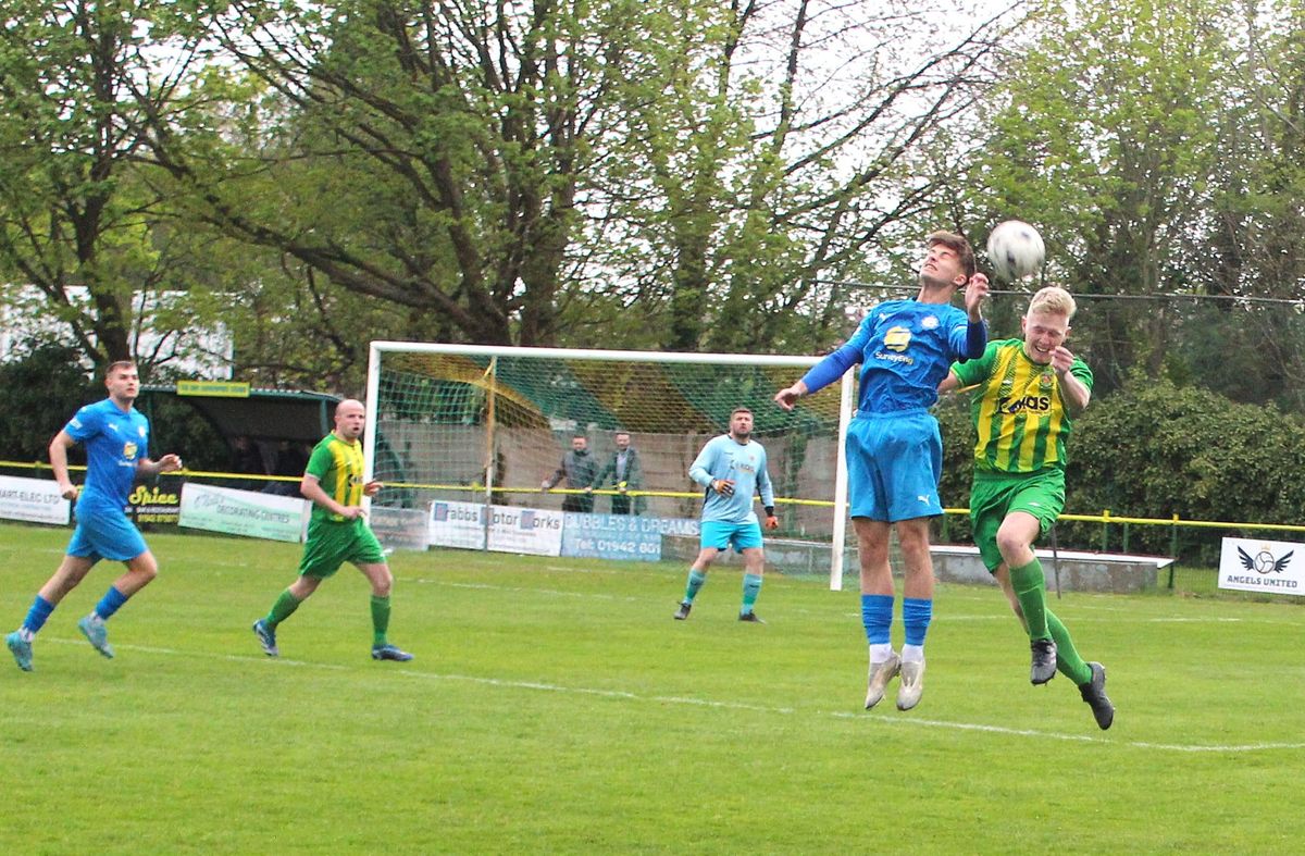Daisy's Liam Sheppard challenges Atherton Town's Kieran Morris