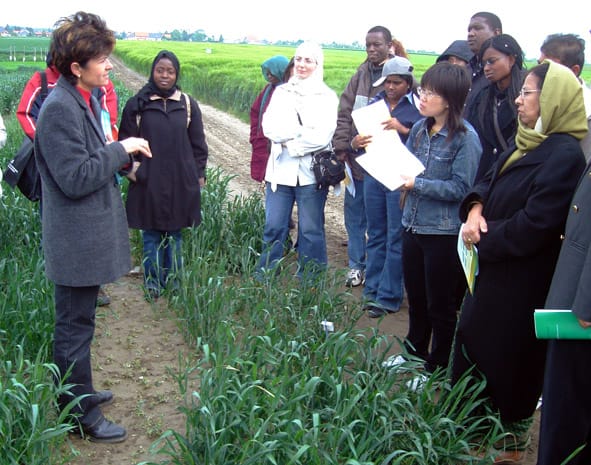 A group of people listening to a talk on crops.