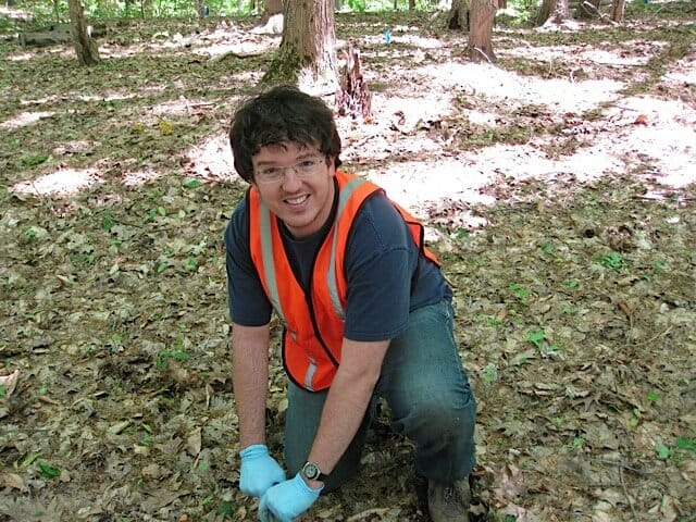 Former University of Michigan postdoctoral research fellow Zac Freedman collects a soil sample at a study site in Oceana County, Michigan