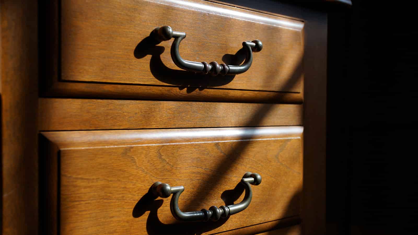A set of drawers moodily lit hinting at the mystery of what they contain.