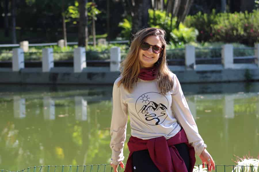 A young lady smiling by the waterfront.