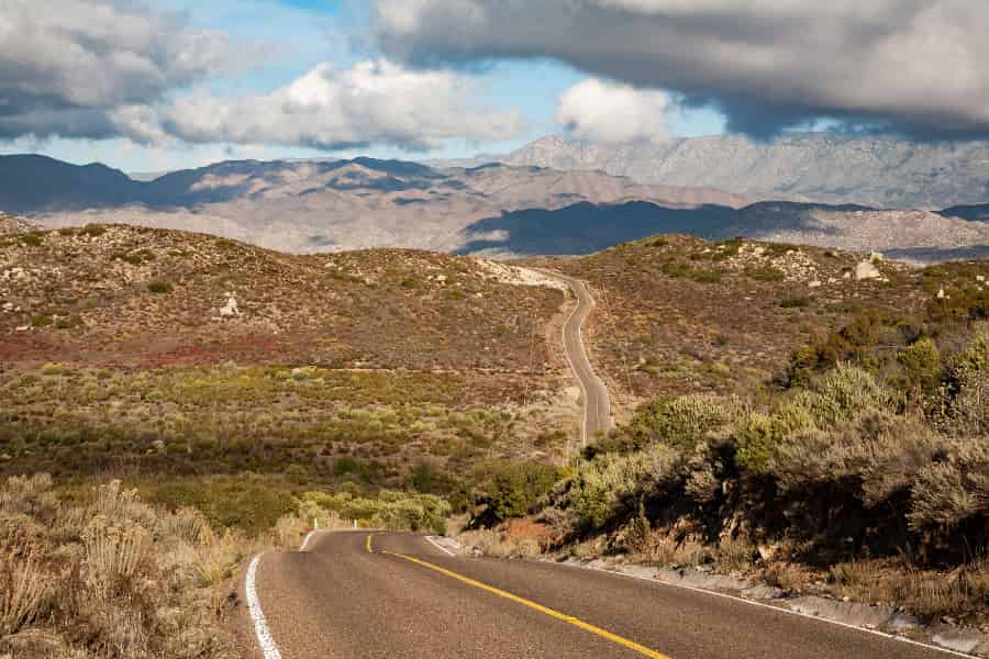 A road gently winds as it travels across the dry landscape of the Sierra San Pedro Mártir. 