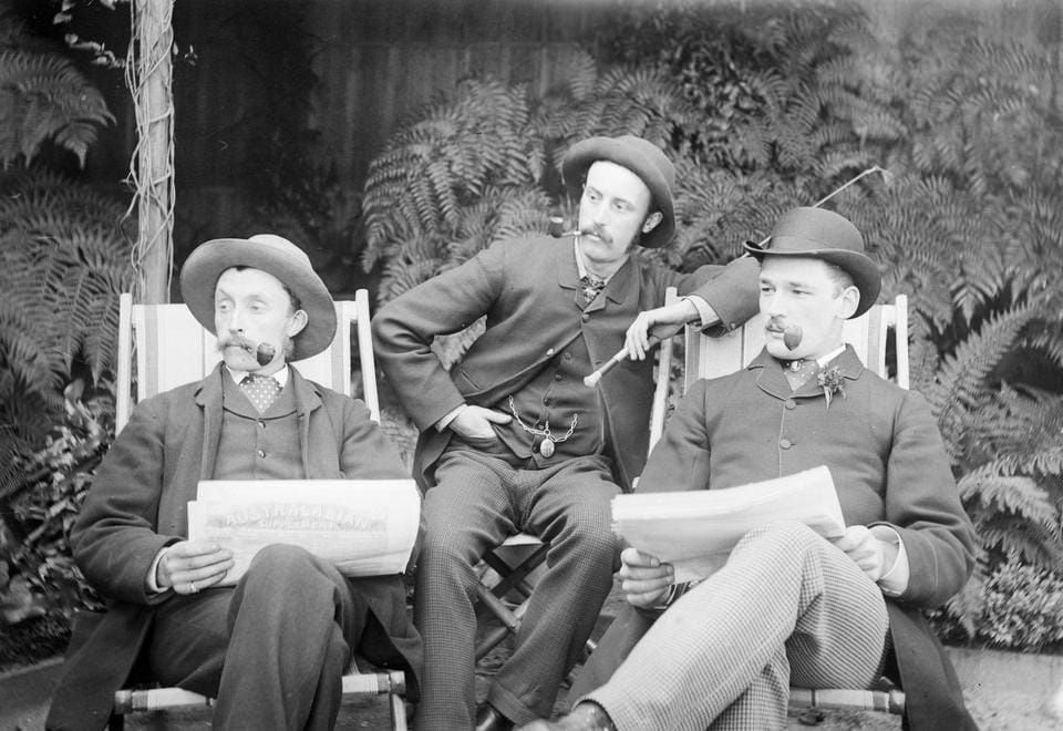 Three men, reading