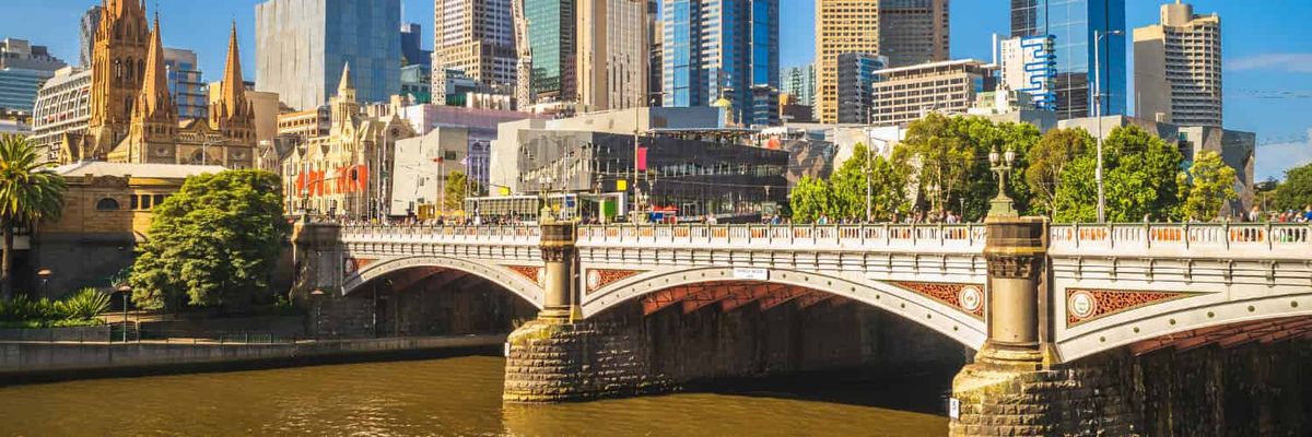 A bridge to the CBD in Melbourne. Trees are visible along it.