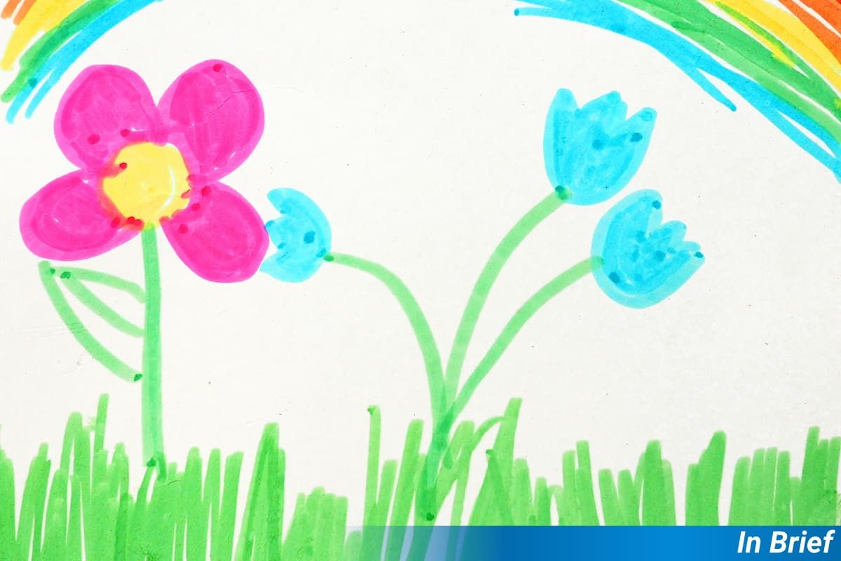A child's drawing of flowers, with a rainbow in the sky.