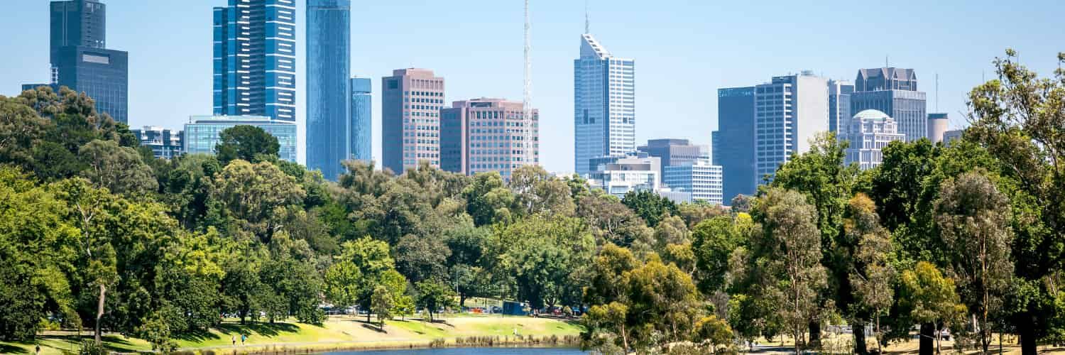 View of the Melbourne skyline, with plenty of trees in the foreground.