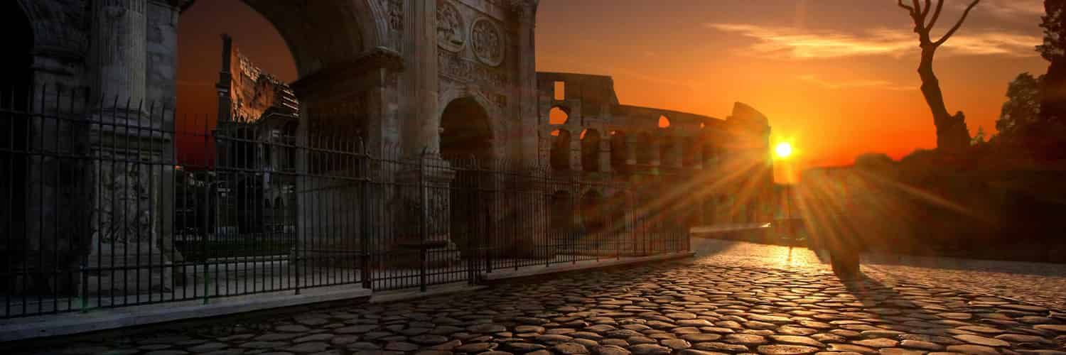 The Arch of Constantine and Colosseum in Rome in a red red sunset.