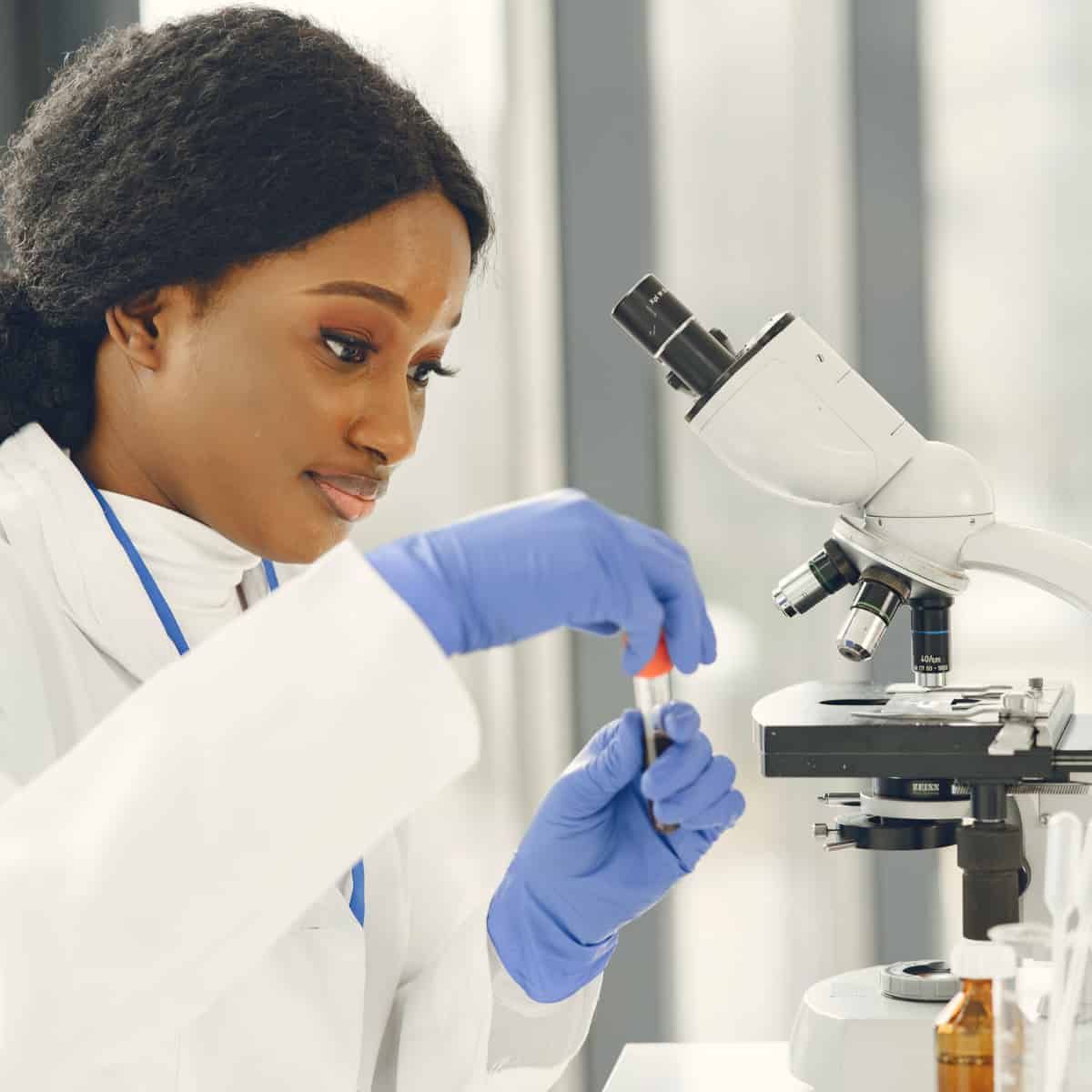 A young lady using a microscope. This almost certainly isn't an accurate image of the process, but it puts an image of a micr