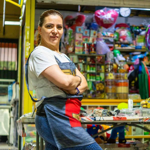 Woman standing in front of her stall in Mexico. She may or may not be a mother, but she looks strong and independent.