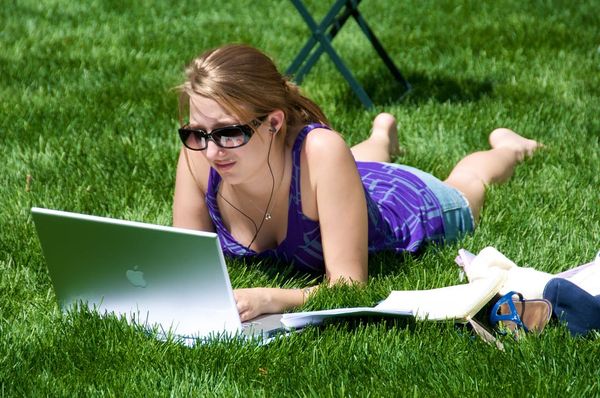 Woman blogging (?) in the park.