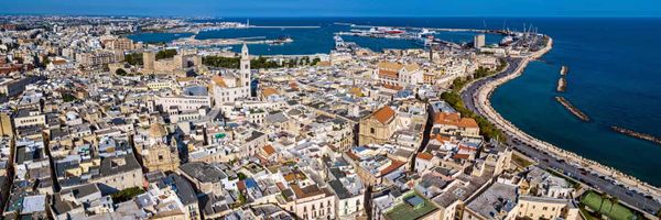 An aerial view of a city much of it white or terracotta.