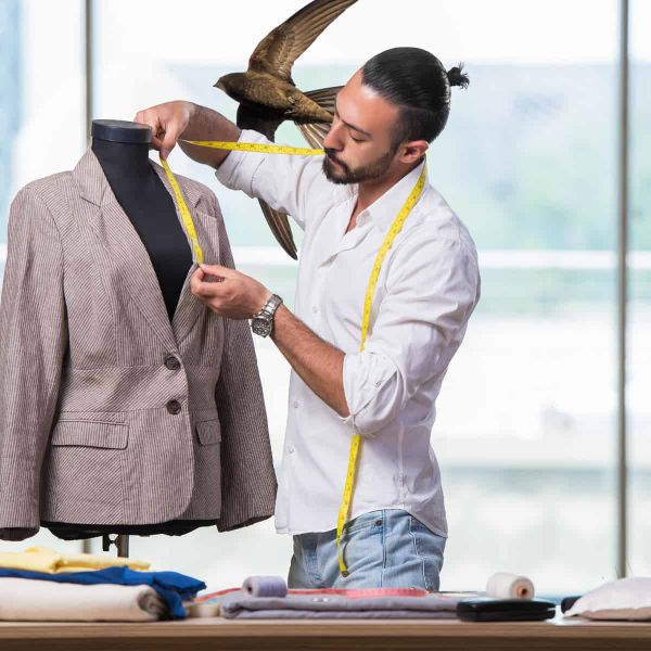 A tailor works while, in the background, a massive swift flies past in a way that isn't going to cause copyright problems.
