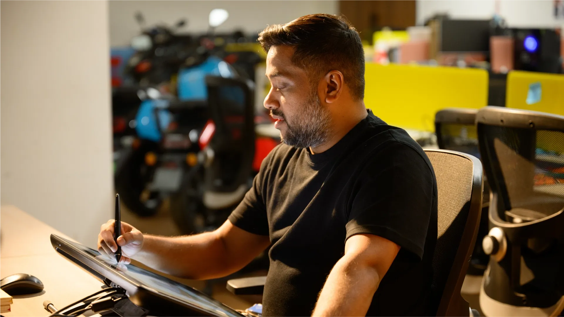 River Mobility's Co-founder and Head of Product, Vipin George at a desk digitally sketching