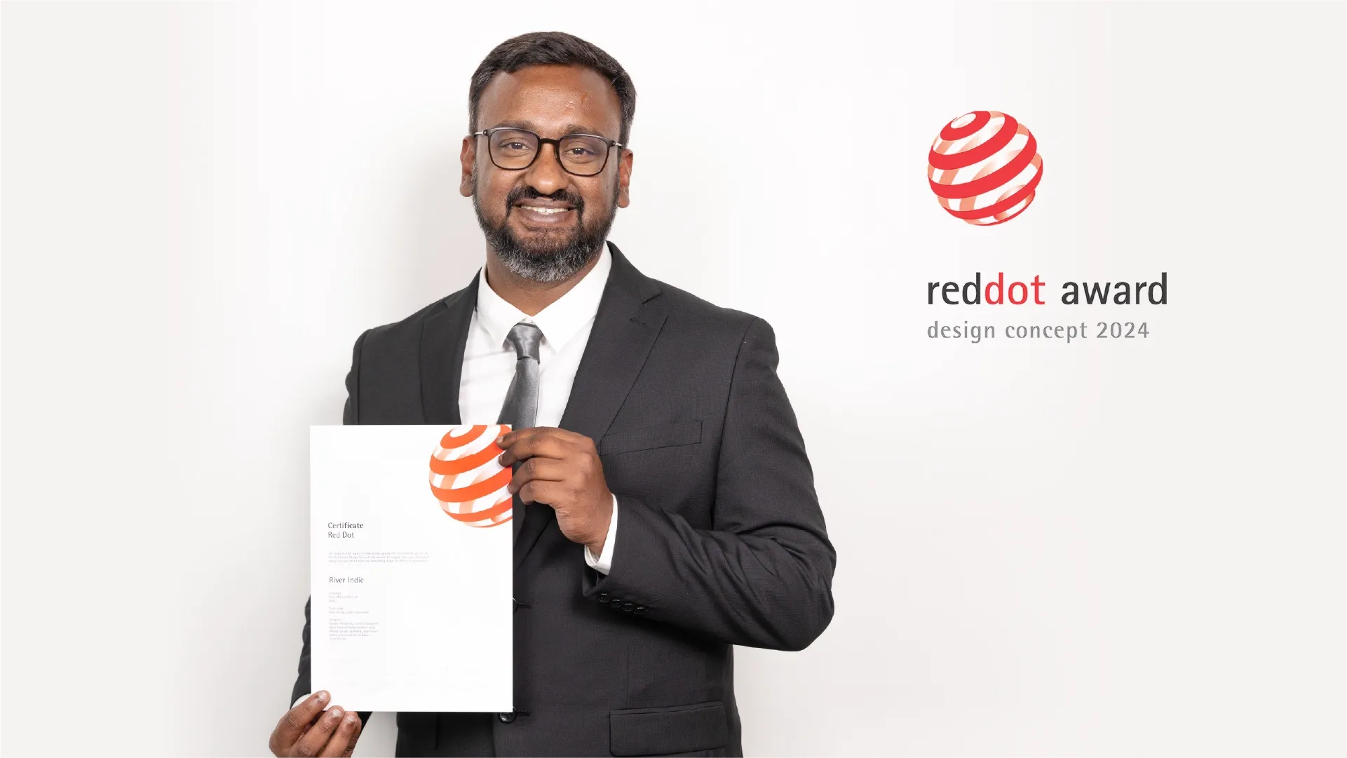 Appu Koshy, River's Design Manager: Industrial Design, proudly holding the Red Dot Award for Design Concept 2024